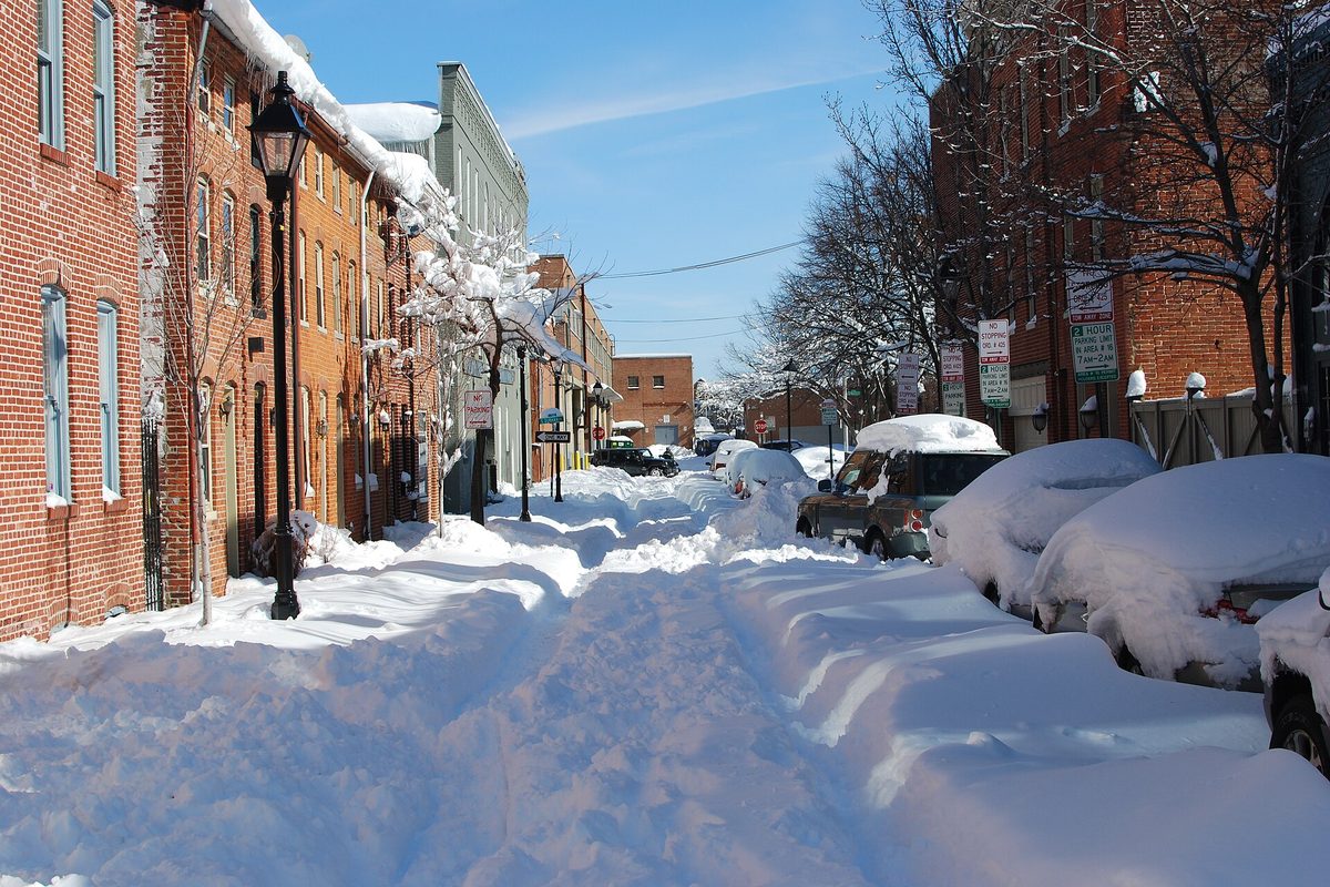 Snow-covered Baltimore row house street after a major storm
